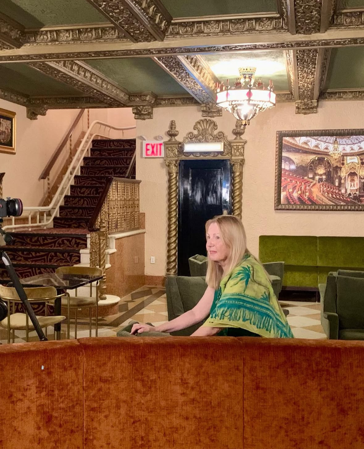 Susan Arann seated in the restored VG Lounge, showcasing her design work and historic preservation expertise.