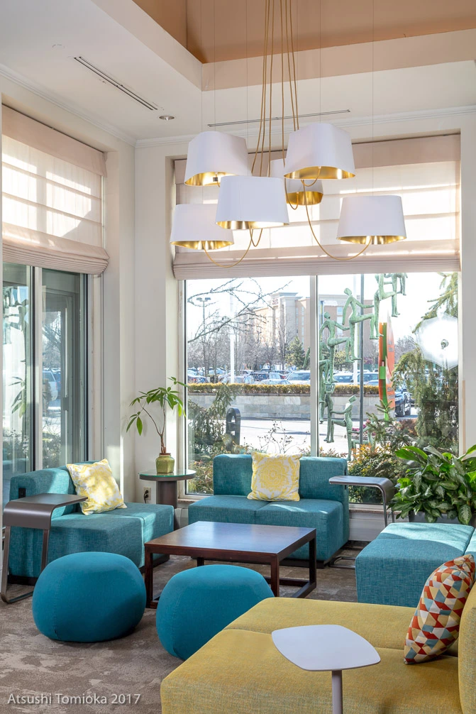 Modern hotel lobby at Hilton Garden Inn Staten Island with stylish seating, custom lighting, and contemporary interior design.