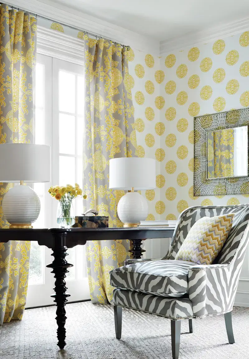 Elegant room with yellow and white circular-patterned wallpaper, matching drapery, and zebra-patterned upholstery creating a bold, stylish contrast.